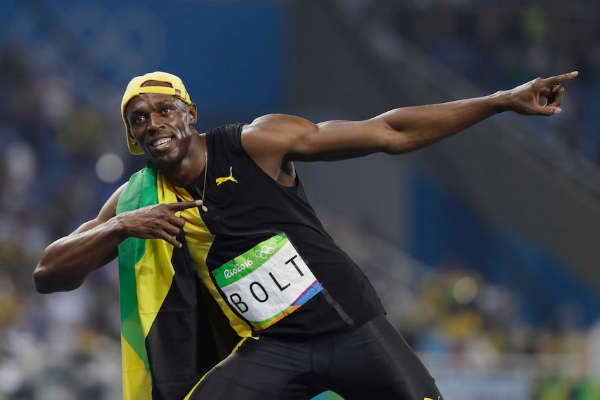 Usain Bolt pulls his famous lightning bolt pose after winning 100m gold in Rio