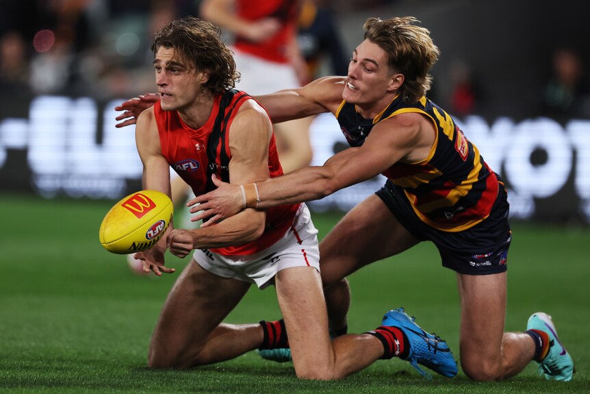 Harrison Jones is on his knees as he is tackled