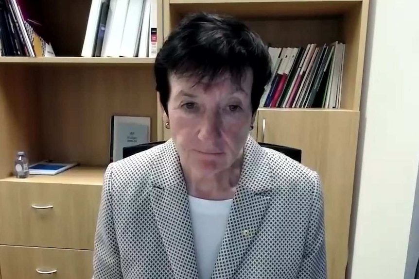 A woman seated in an office.