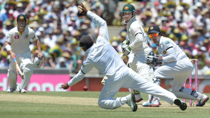 Australia's Phil Hughes edges short of Mahela Jayawardene against Sri Lanka.