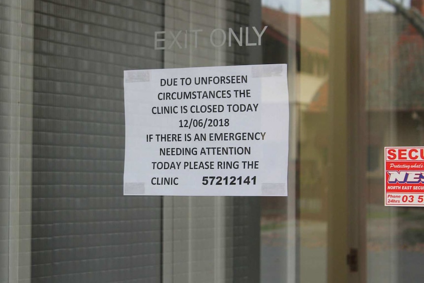 A sign on a window says the clinic is closed for the day due to unforseen circumstances.
