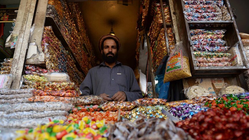 A shopkeeper in Kabul waits for customers at his sweetshop ahead of the Eid festival