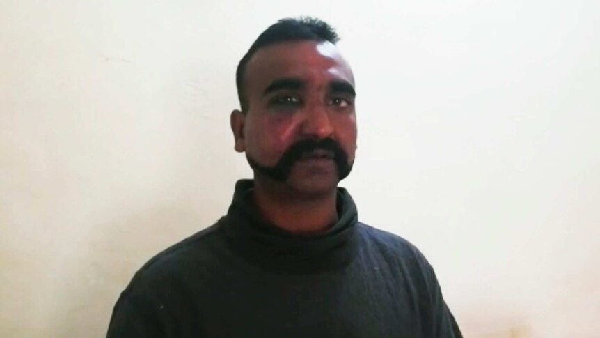 A still shot of an Indian man taken from a video.