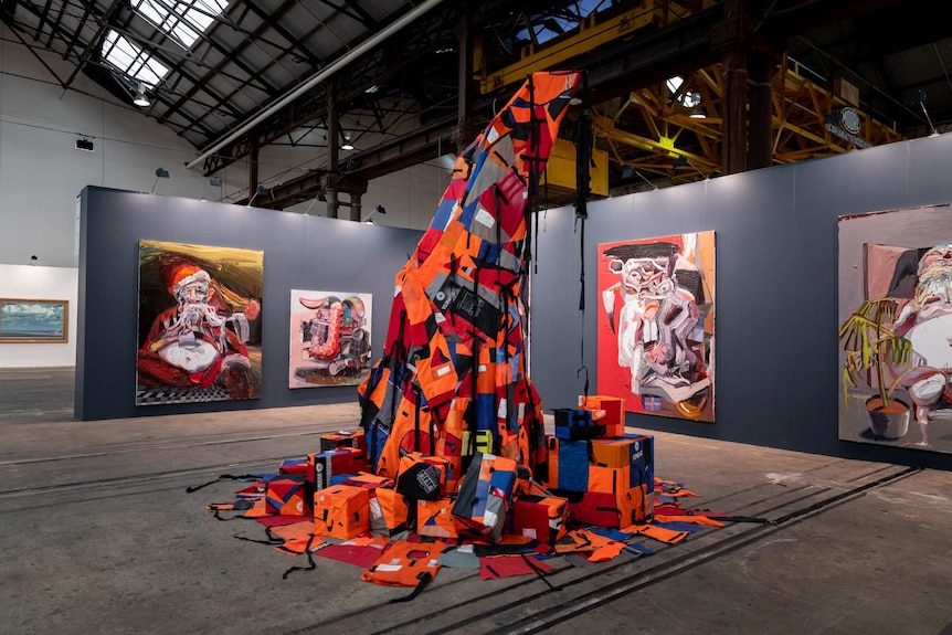 A christmas tree made up of life jackets, with lights glowing underneath the jackets