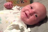 Smiling baby on a blanket