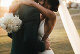 Interracial couple embracing on their wedding day in a story about falling in love with someone outside your culture.