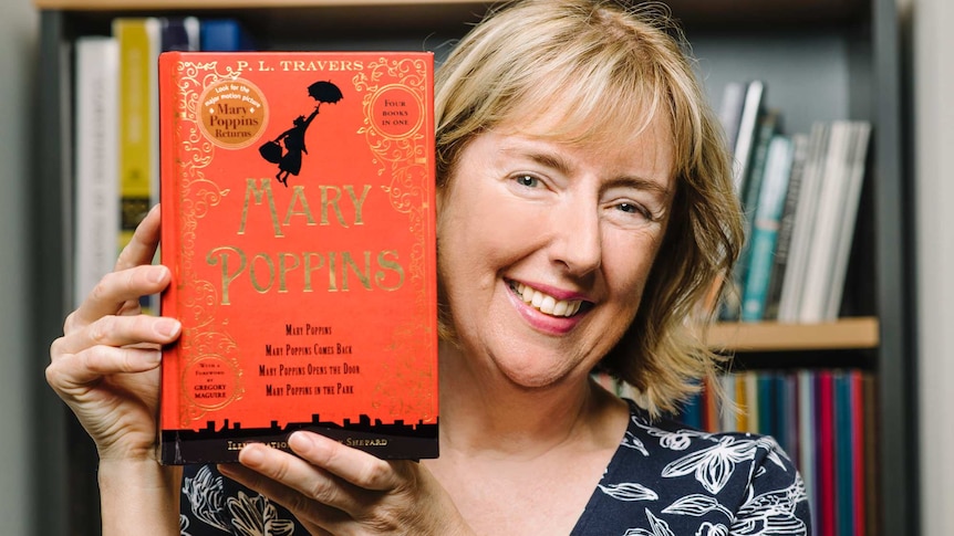 Dr Margaret Baguley hold a copy of the book Mary Poppins.