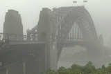 The Sydney Harbour Bridge stands amid a grey sky as torrential rain batters the city.