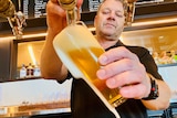 A man pours a beer