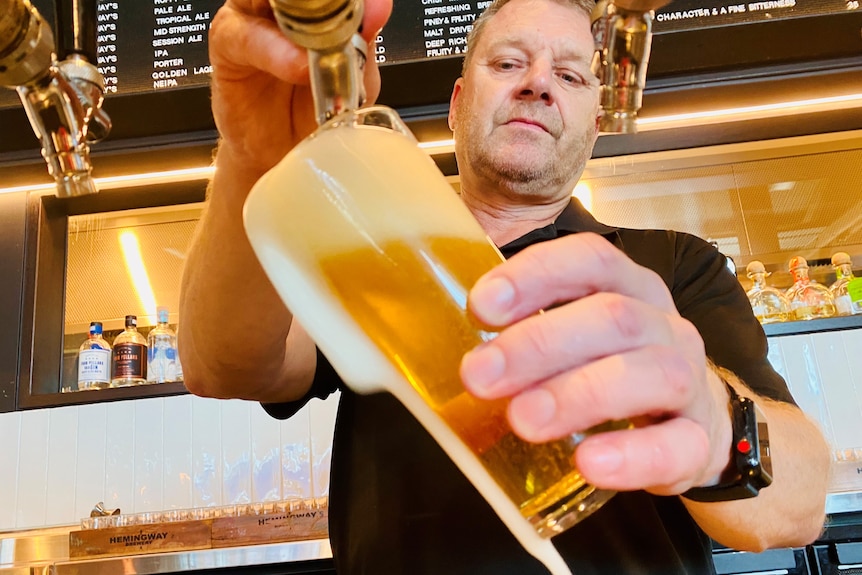 A man pours a beer