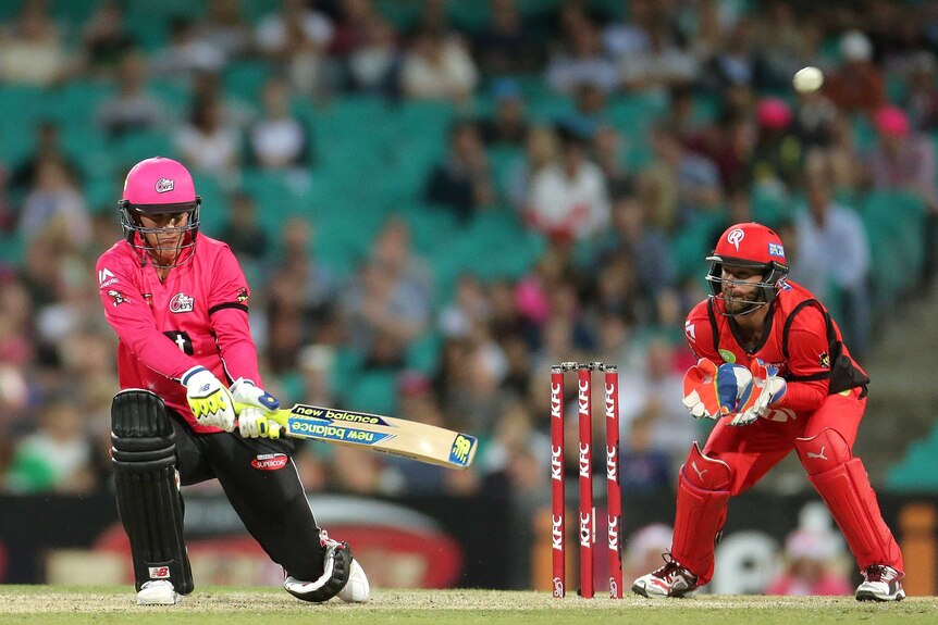Nic Maddinson hits a six for the Sydney Sixers against the Melbourne Renegades