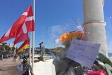 Flowers are left at a beachfront memorial in Nice.