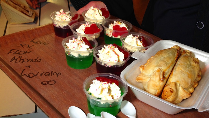 A tray of food, including frogs in a pond jelly cups.