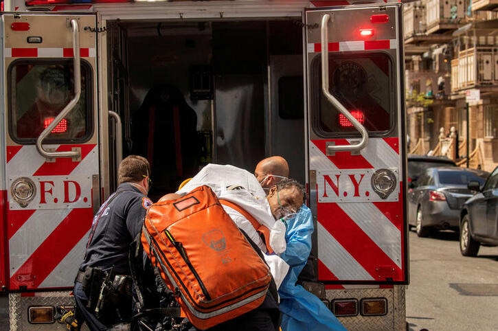 A man on a stretcher being lifted into the back of an FDNY truck