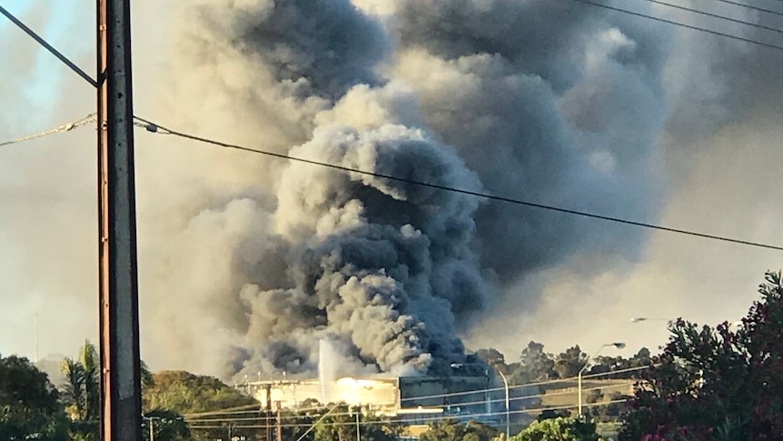 Smoke billows from a meat factory fire.