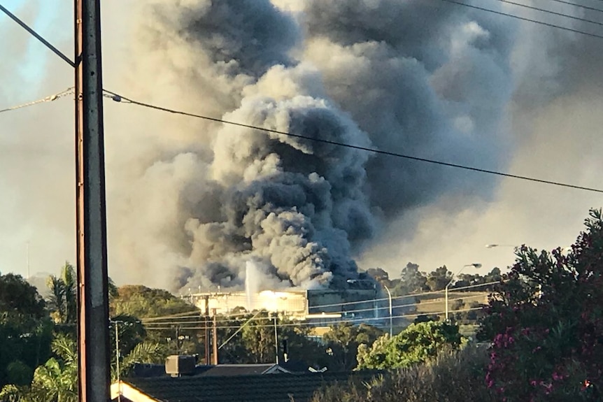 Smoke billows from a meat factory fire.