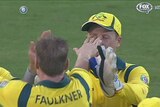 Australia's James Faulkner pokes Brad Haddin in the eye during the first ODI against India.