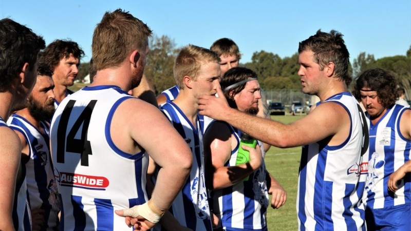 Buchan Football Club players stand and talk together