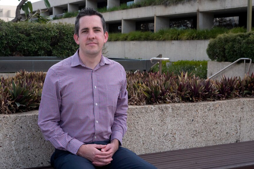 David Edwards sits on a bench in Brisbane, for a story about perinatal depression and anxiety for men.