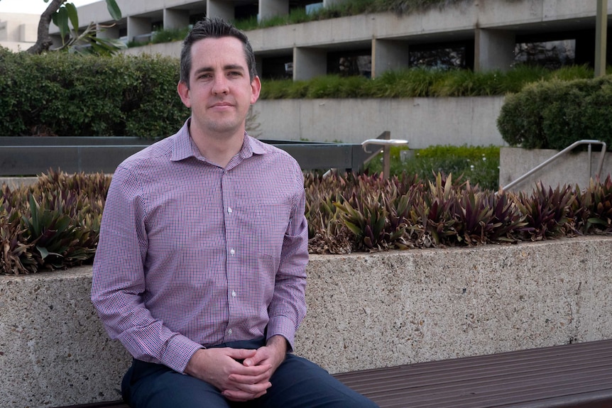 David Edwards sits on a bench in Brisbane, for a story about perinatal depression and anxiety for men.