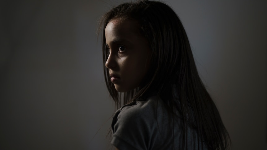 Suzy Ishkontana, 7, poses for a portrait in the house of a family member where she is currently living