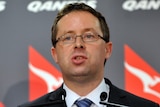 Qantas CEO Alan Joyce speaks to the media