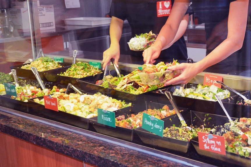 A salad bar with options colour green (for healthy) or red (for not-so-healthy).