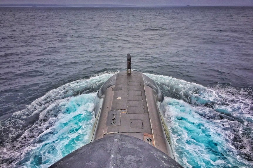 HMAS Waller rises to the surface of the ocean
