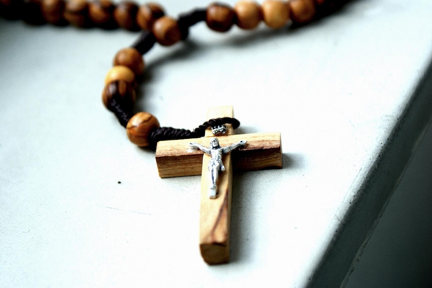 A crucifix cross on a bead necklace