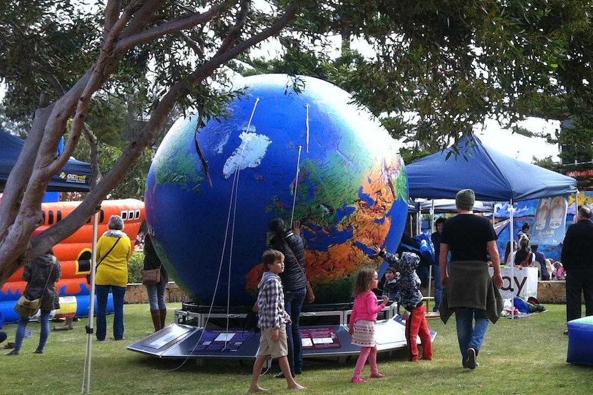 Children inspect inflatable globe at a park in Geraldton