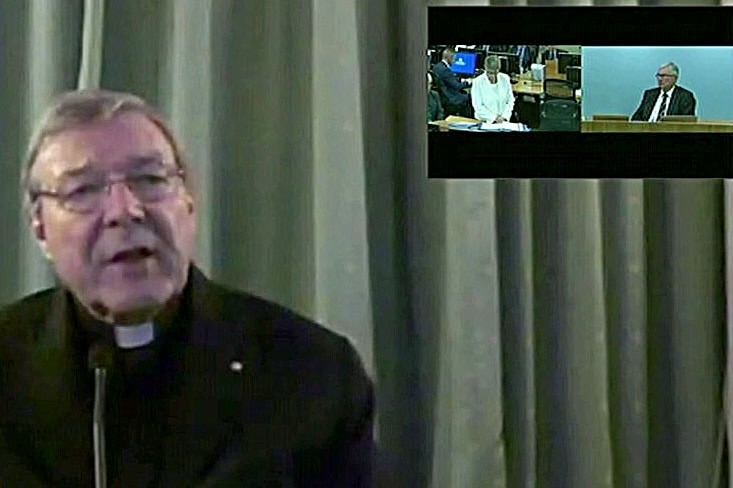 Cardinal George Pell sits in front of a curtain as he gives evidence to the Royal Commission into child sexual abuse.