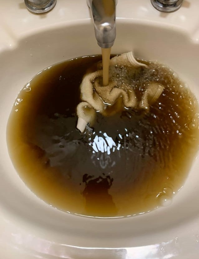 Brown water in a sink. 