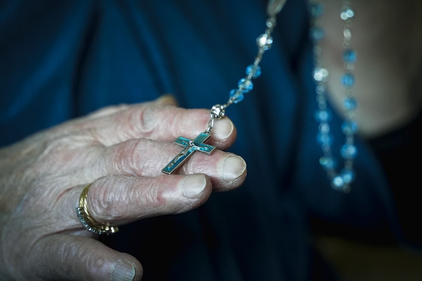 Nerina Callea holds a Christian cross necklace