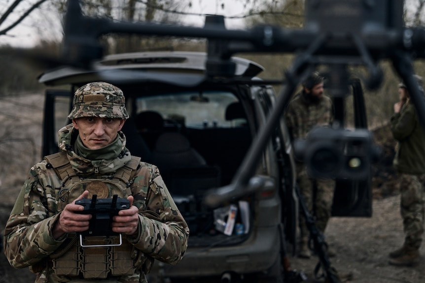 A Ukrainian soldier launches a drone in the area of the heaviest battles with Russian troops.