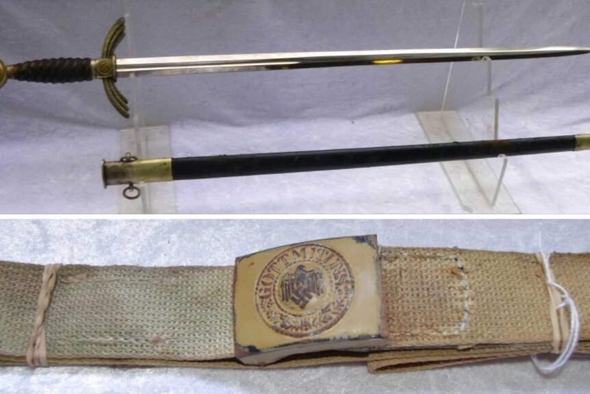 A WW11 Third German SA dagger with swastika and belt for sale at NSW military memorabilia auction.