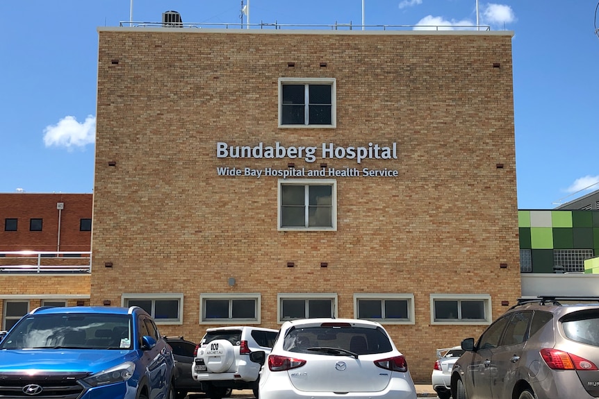 A photo of a brick building with a sign saying Bundaberg Hospital.
