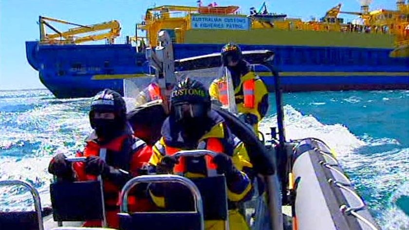 An Australian Customs team leave the Customs ship Oceanic Viking