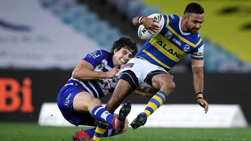 Bevan French is tackled by Lachlan Lewis in the Parramatta versus Canterbury match.