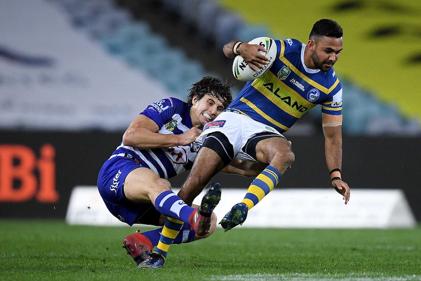 Bevan French is tackled by Lachlan Lewis in the Parramatta versus Canterbury match.