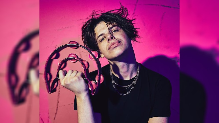 A press shot of 19-year-old UK Northerner YUNGBLUD brandishing a tambourine