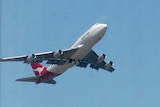A Qantas jumbo jet takes off at Sydney Airport.