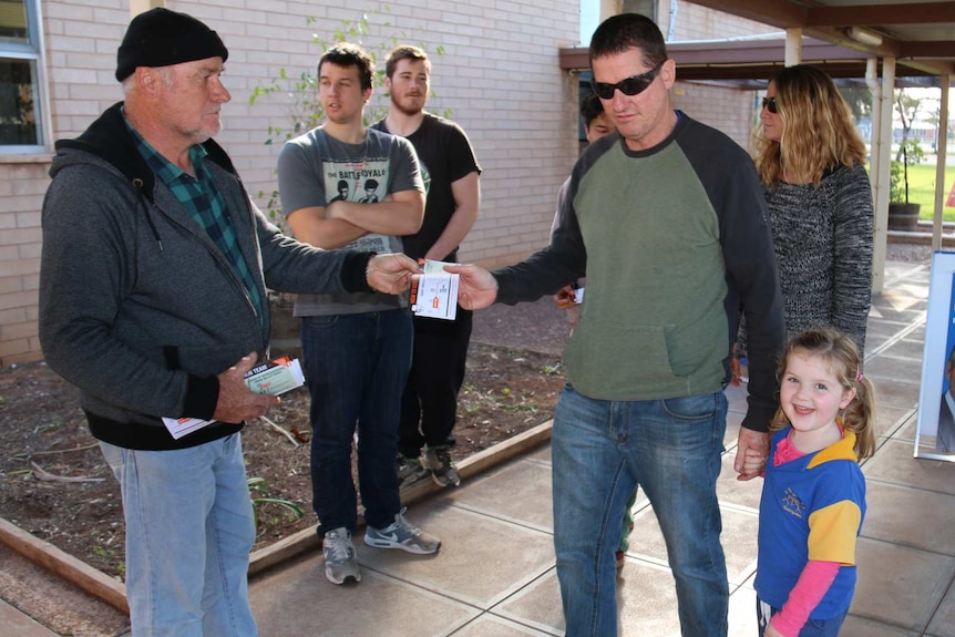 Voters arrive at to cast their votes at a polling booth.