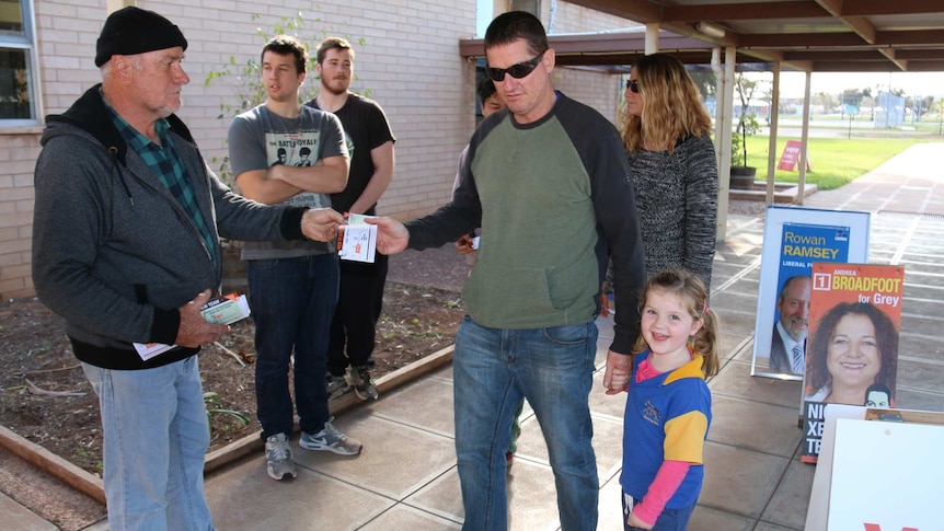 Voters arrive at to cast their votes at a polling booth.