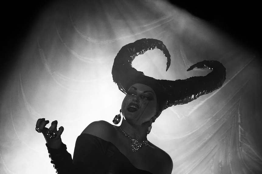 Black and white photo of drag queen with horned hat