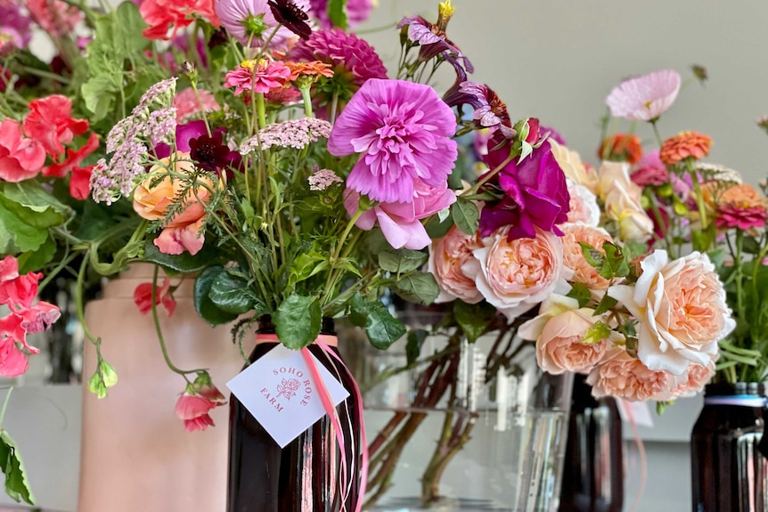 Colourful flowers sit in vases, ready for sale on Valentine's Day