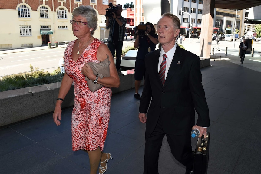 A woman and man arrive at court