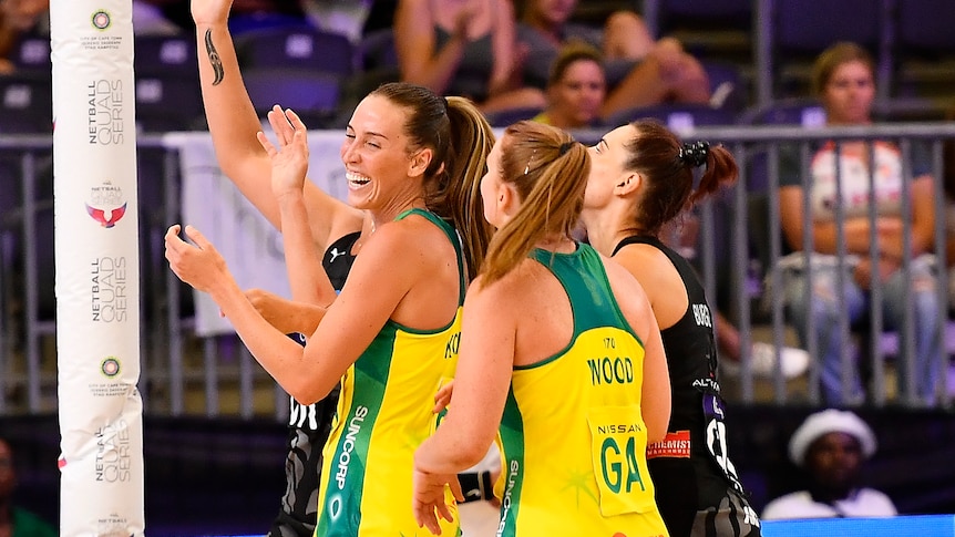 Australian Diamonds Cara Koenen and Steph Wood smile and laugh during a Quad Series netball match against New Zealand.