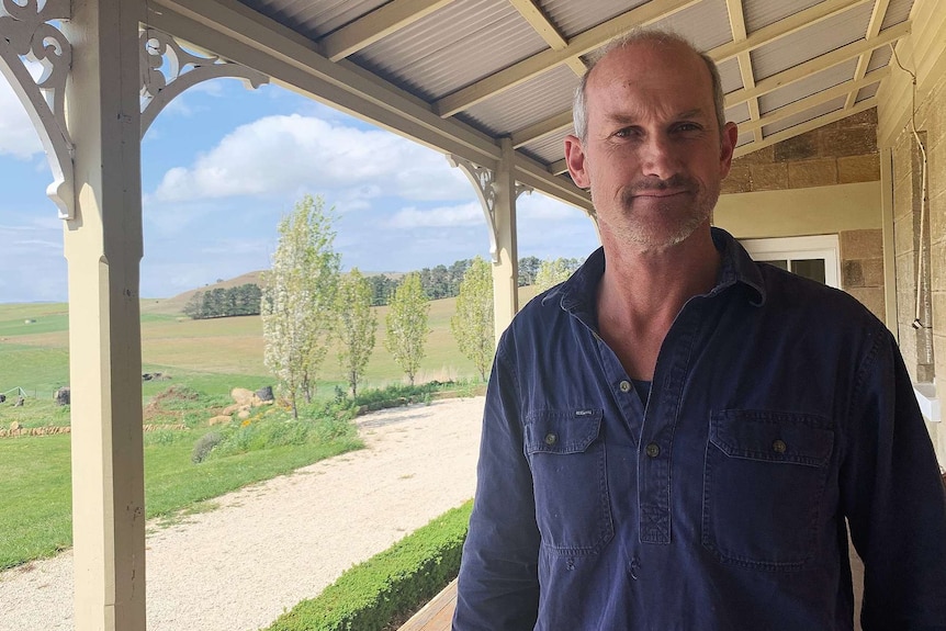 Richard Headlam standing on his verandah at his country house.