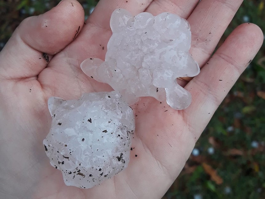 Two large balls of hail in somebody's hand