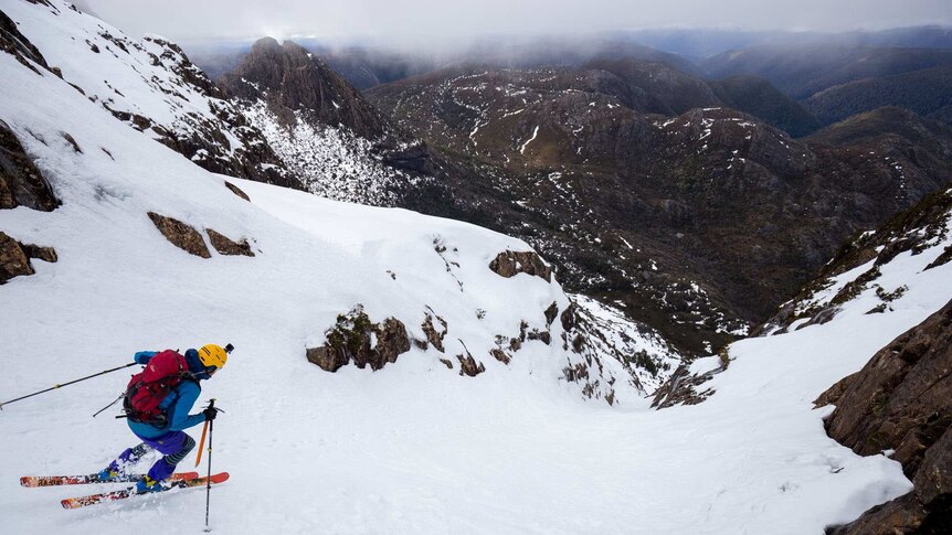 Skier takes off on Cradle Mountain